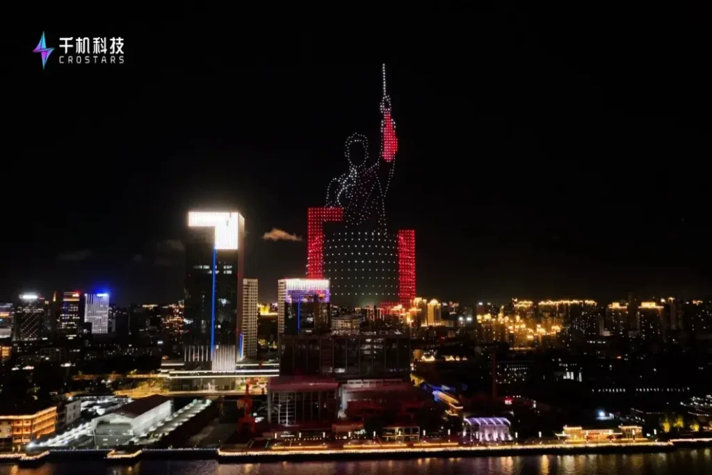 Crostars 1000-drone light show forming Wang Leehom concert tour imagery over Shanghai Yangpu riverfront skyline at night, August 2025