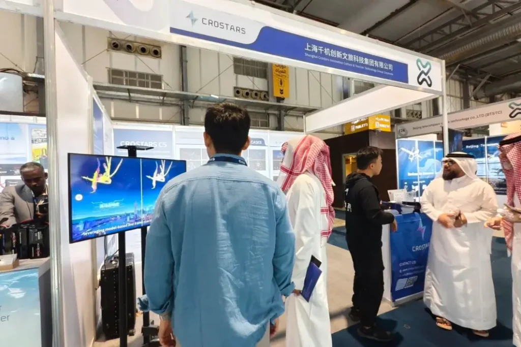 Crostars booth F31 at SADEX 2025 in Riyadh, Saudi Arabia, with visitors watching C5 drone light show demo on screen
