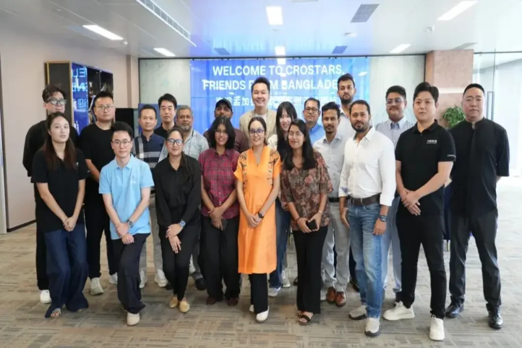 Crostars team and Bangladesh drone training delegation group photo at Shanghai headquarters, August 2025 — Welcome to Crostars Friends from Bangladesh banner visible in background