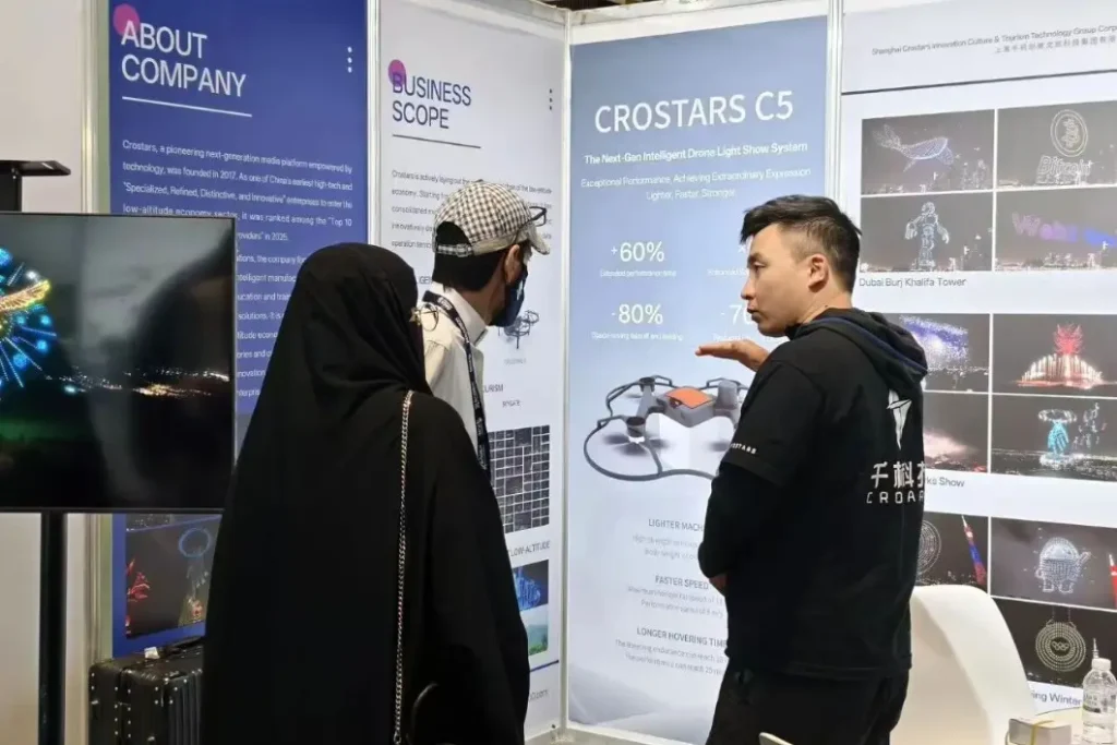 Crostars team member explaining the C5 drone light show system to a visitor at SADEX 2025 Saudi Arabia drone exhibition