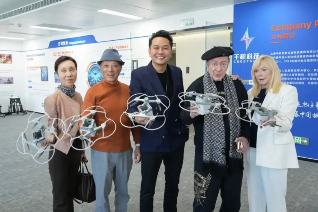 Charles Billich and Crostars team holding C5 drone light show system units during showroom tour at Crostars Shanghai office