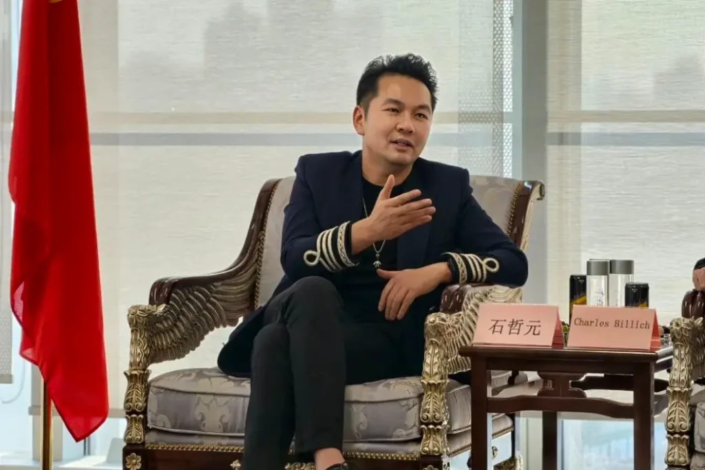 Crostars Chairman Shi Zheyuan speaking during discussion with Olympic artist Charles Billich at Crostars Shanghai headquarters