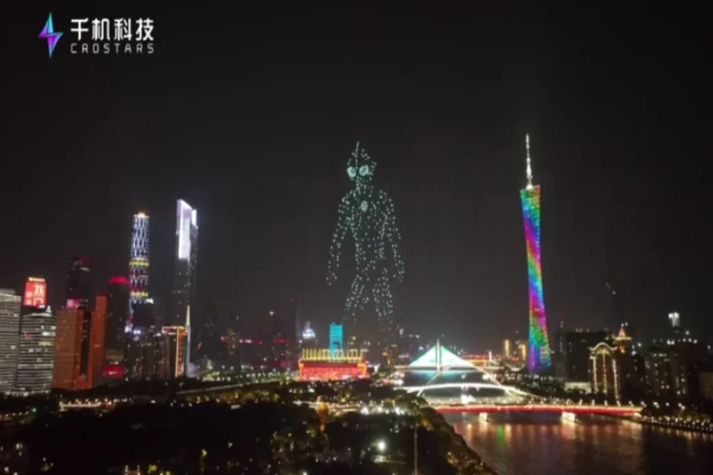 Crostars drone light show night performance forming Ultraman Blazer figure over Guangzhou skyline with Canton Tower, 2023