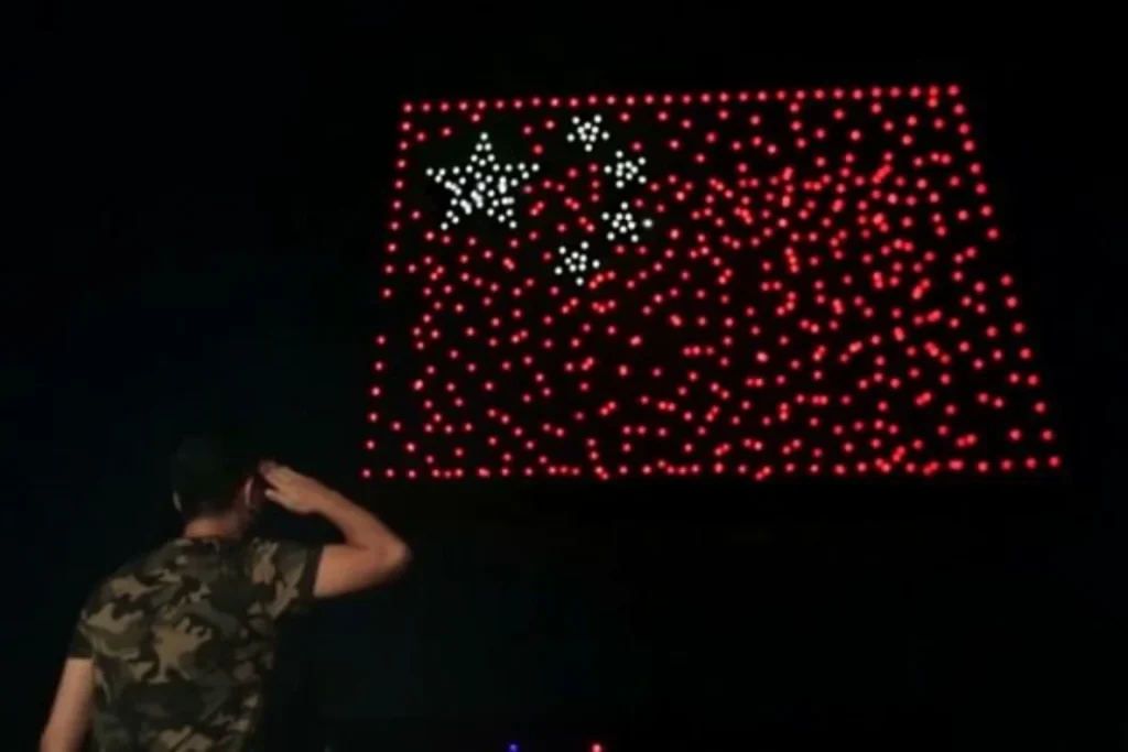 Crostars drone light show night performance forming Chinese national flag in red and white